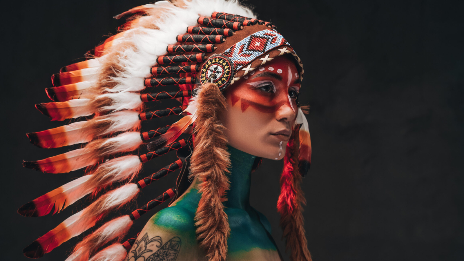 Woman wearing a traditional feathered headdress, evoking Native American cultural imagery